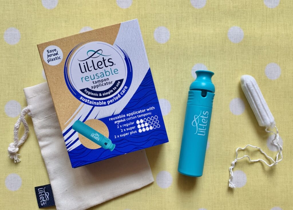 Contents of a reusable tampon applicator pack laid out on a table.