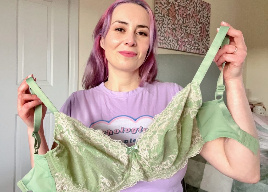 Becky holds up the Panache Ana bra in green.